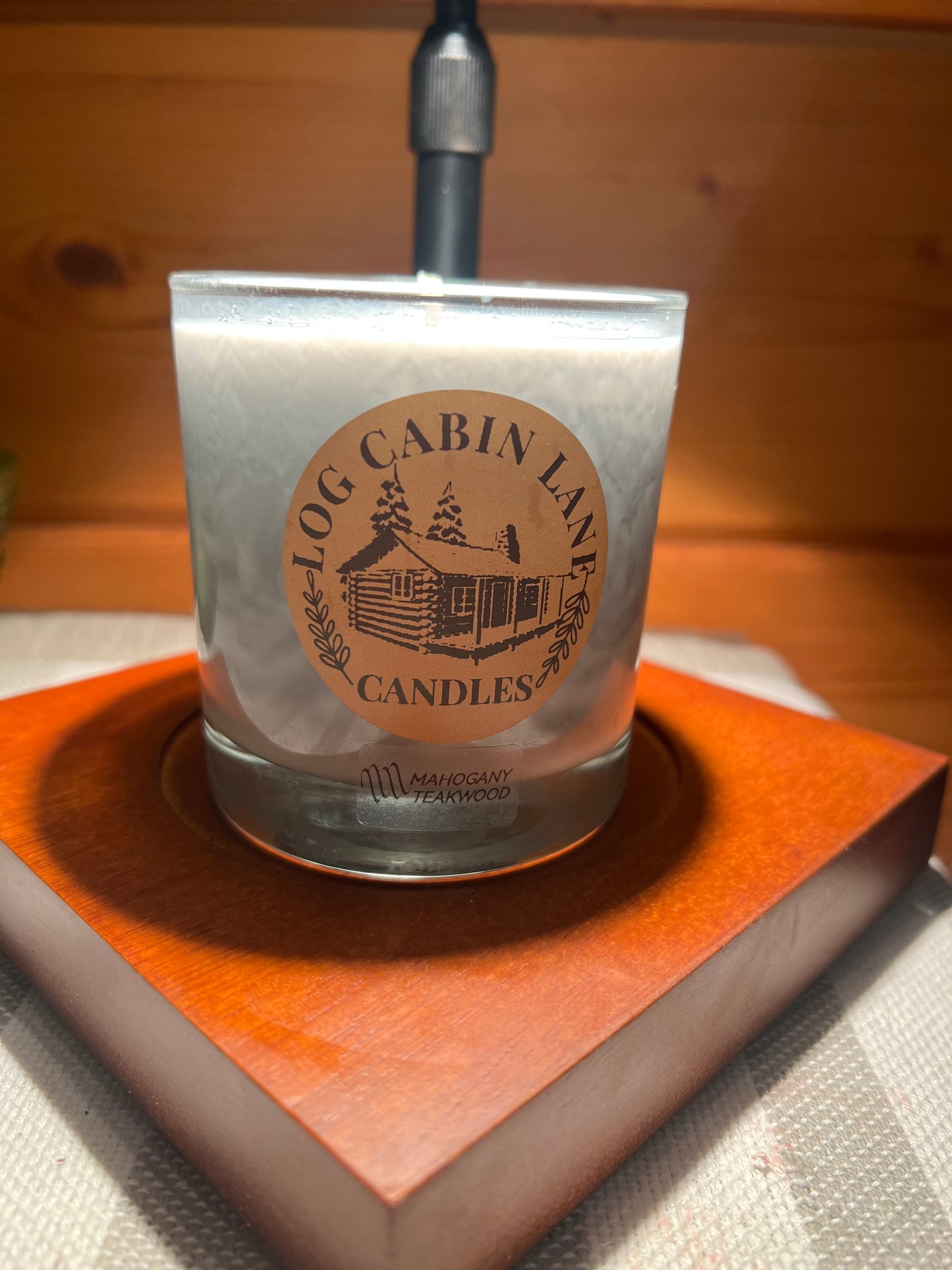 Mahogany teakwood in whiskey glass with wick